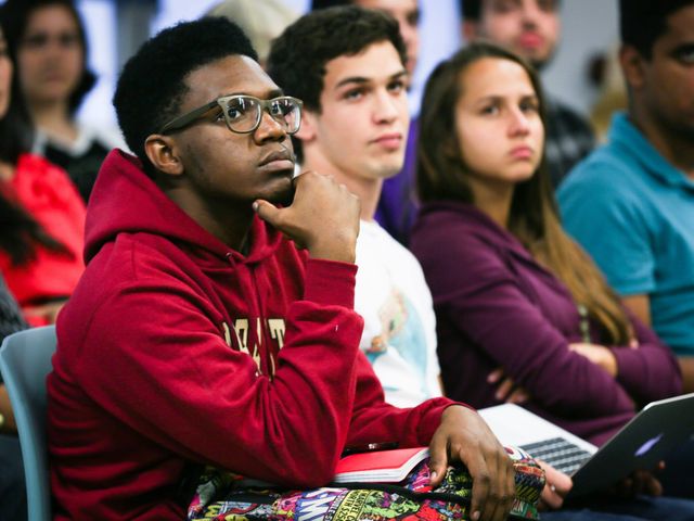 LaunchCode learners listening in class